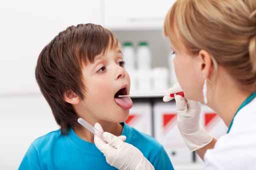 Boy at the doctor being examined and giving biological samples