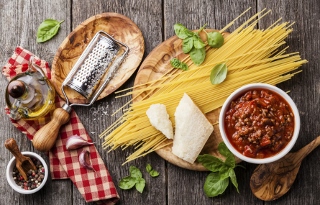 Ingredients for spaghetti bolognese on gray wooden background